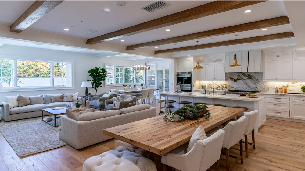 Open-concept kitchen after removing a wall to create a spacious modern living area with island seating.
