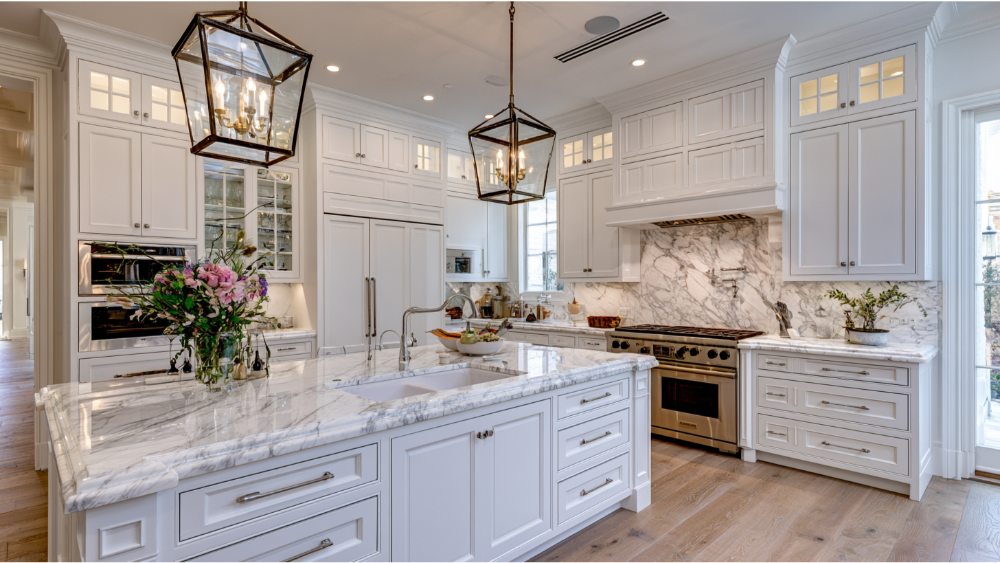 Organized modern kitchen with built-in storage, pantry cabinets, and clutter-free countertops.