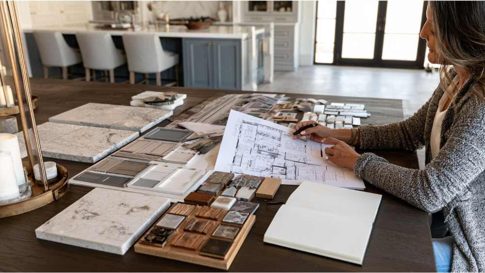 Luxury kitchen design planning with premium material samples, cabinetry drawings, countertop selections, and modern kitchen layout.