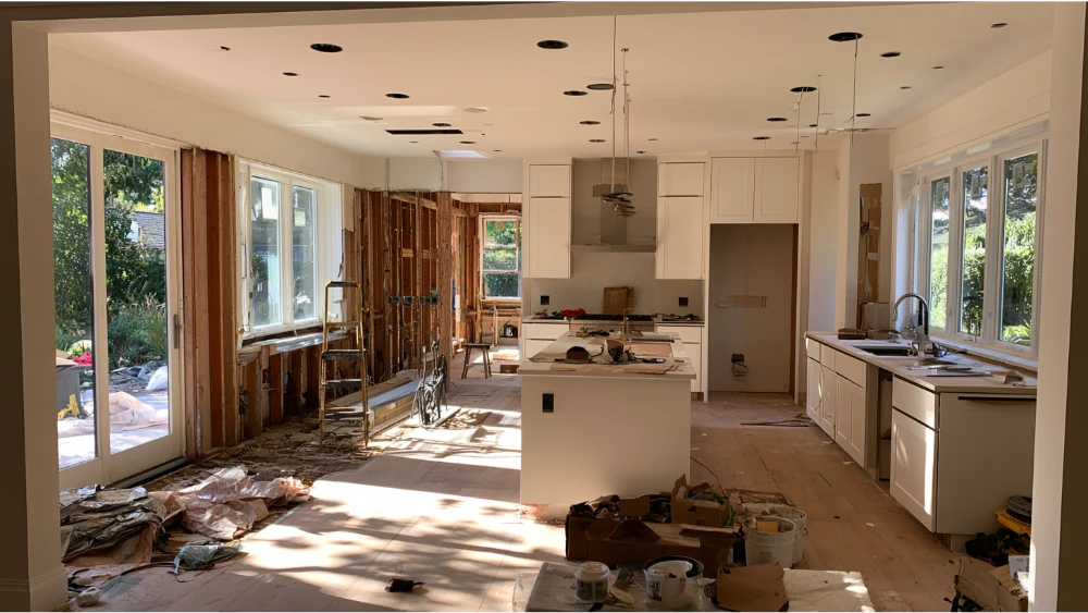 Kitchen remodel progressing through demolition, cabinetry, countertops and finishing stages